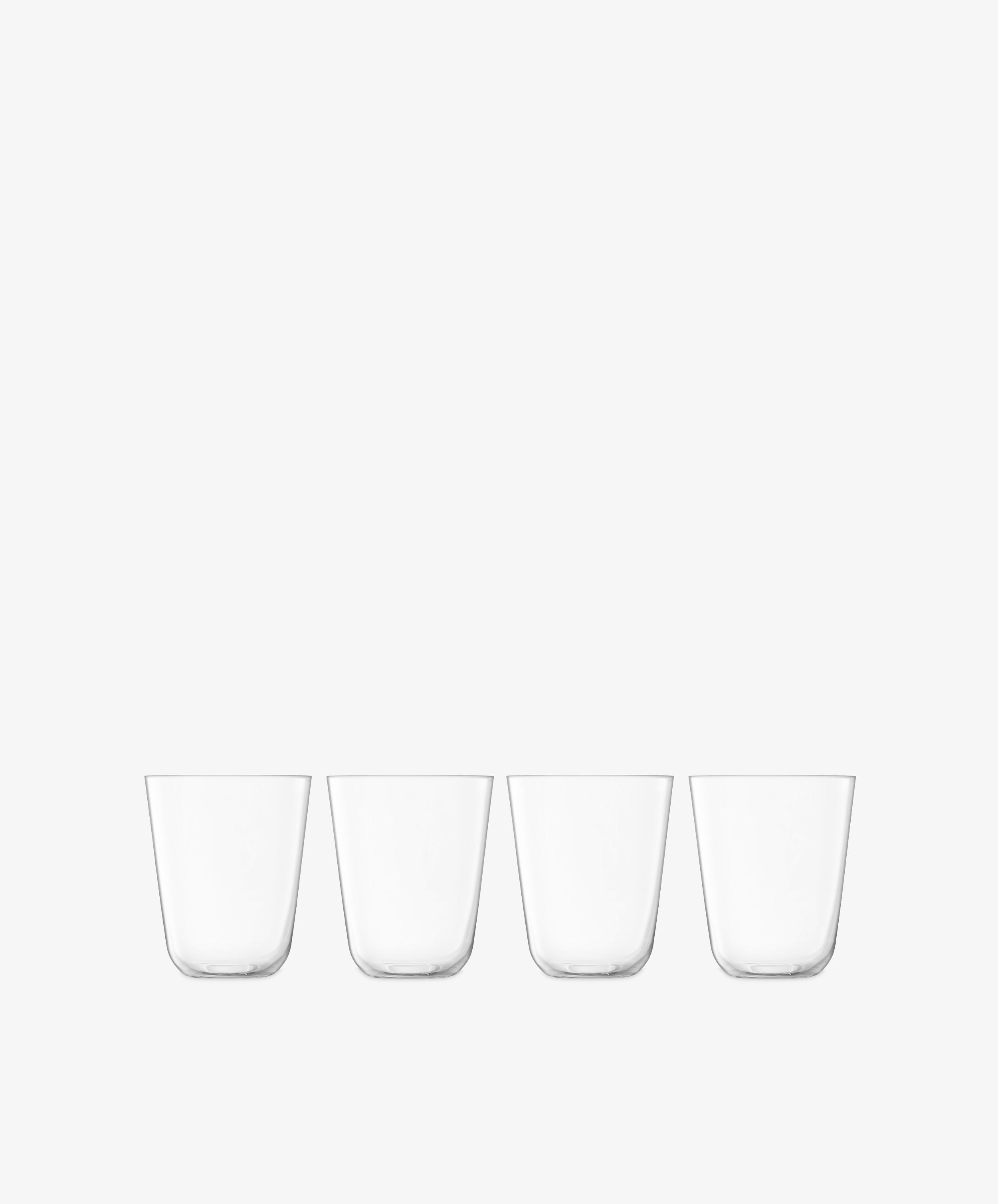 The Arc Tumbler, Set of 4, features clear lead-free glass tumblers arranged in a line on a white background—ideal for everyday use.