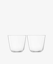 Four empty, clear Arc Tumblers made from lead-free glass are stacked side by side on a plain white background, ideal for everyday use.