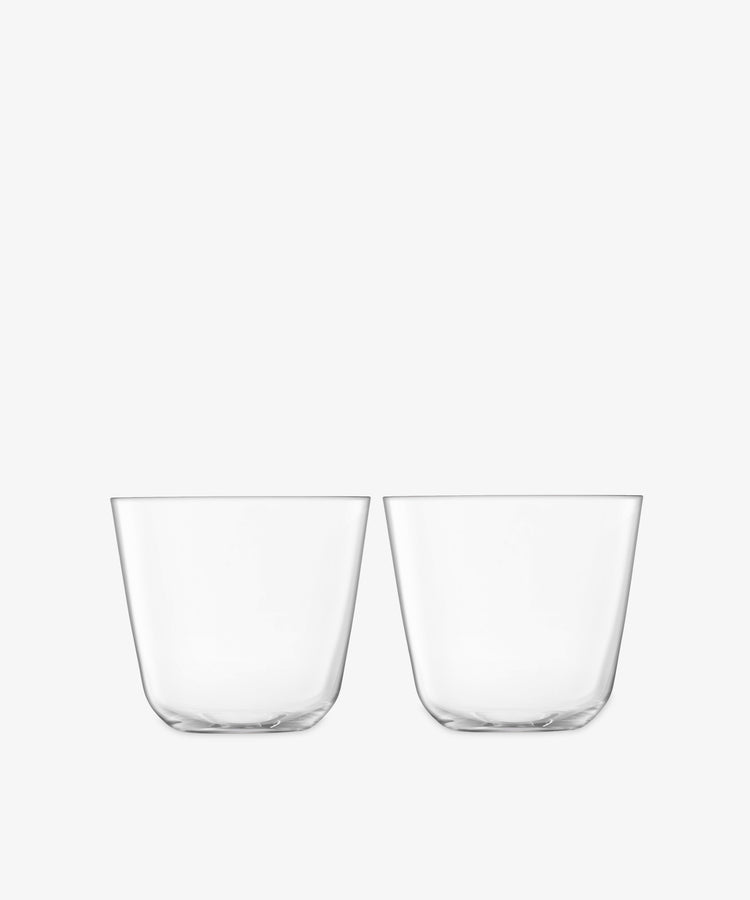 Four empty, clear Arc Tumblers made from lead-free glass are stacked side by side on a plain white background, ideal for everyday use.