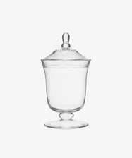 The Bonbon Jar features clear glass with a lid and knob handle, set on a short pedestal base, displayed against a white background.