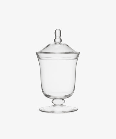 The Bonbon Jar features clear glass with a lid and knob handle, set on a short pedestal base, displayed against a white background.