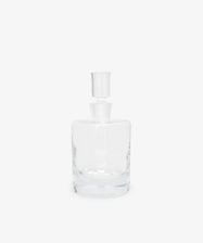 The Boris Decanter features clear glass with an architectural profile and a matching cylindrical stopper, shown against a plain white background.
