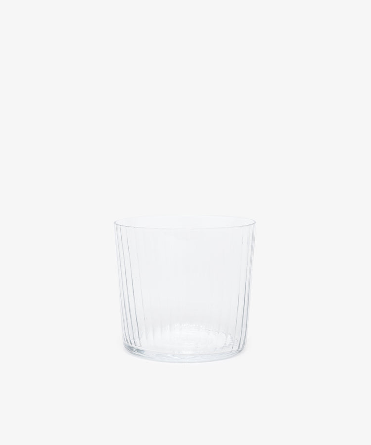 Single clear ribbed tumbler glass.