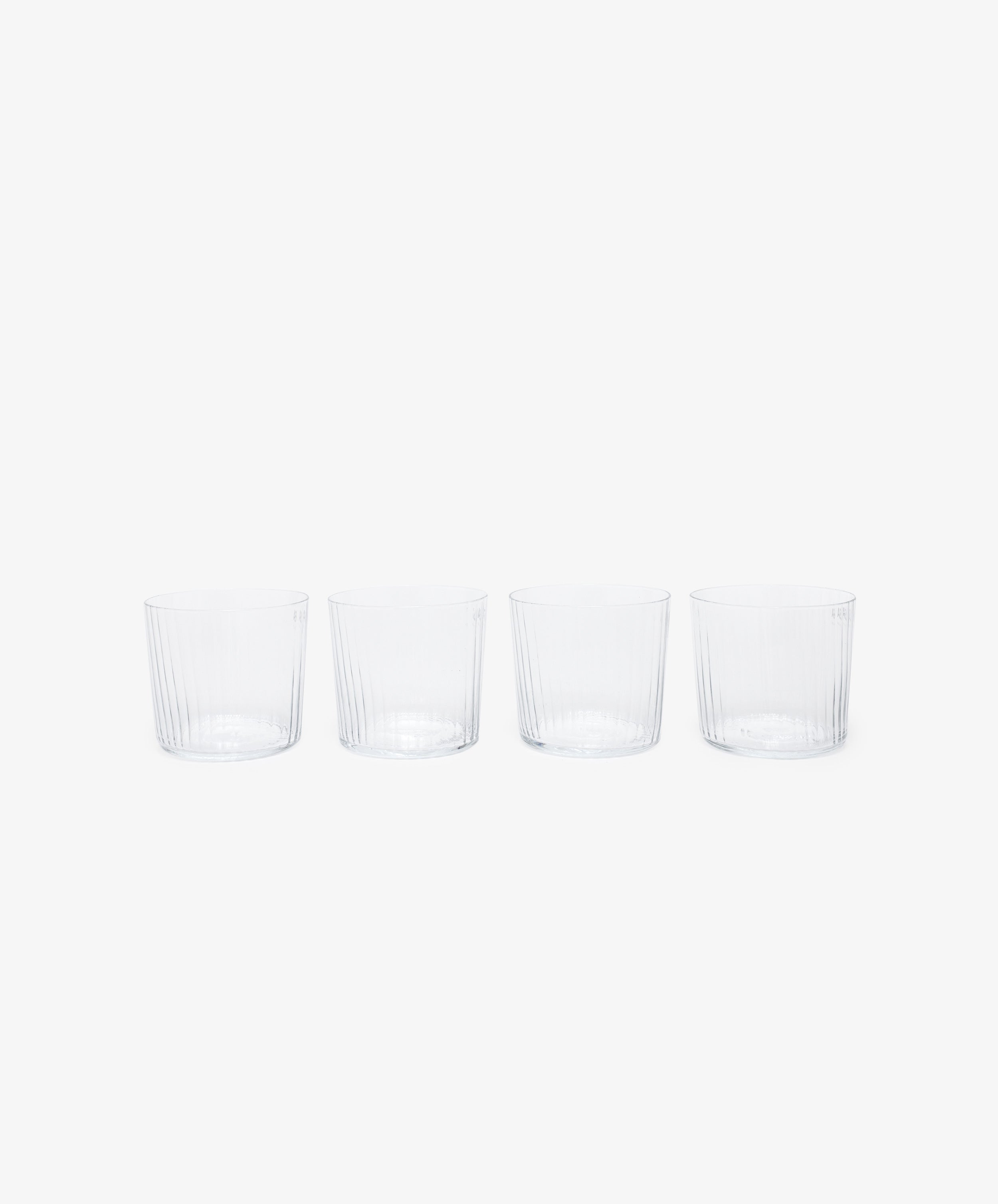 Teo Ridged Tumbler. Row of four of clear ribbed tumbler glasses.