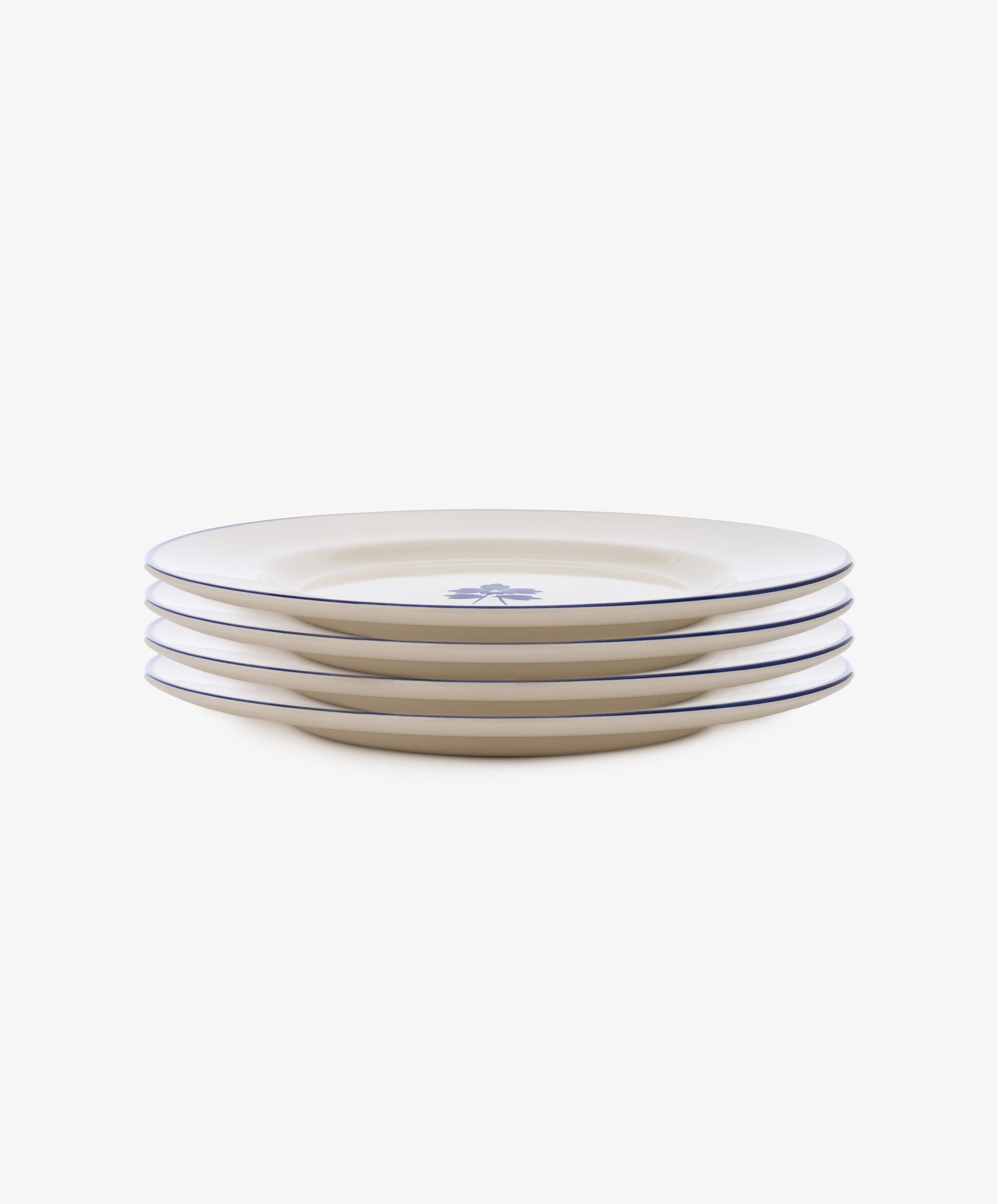 The Beatrix Dinner Plate, Set of 4 features cream ceramic with blue trim and design, giving a classic English blue-and-white china look.