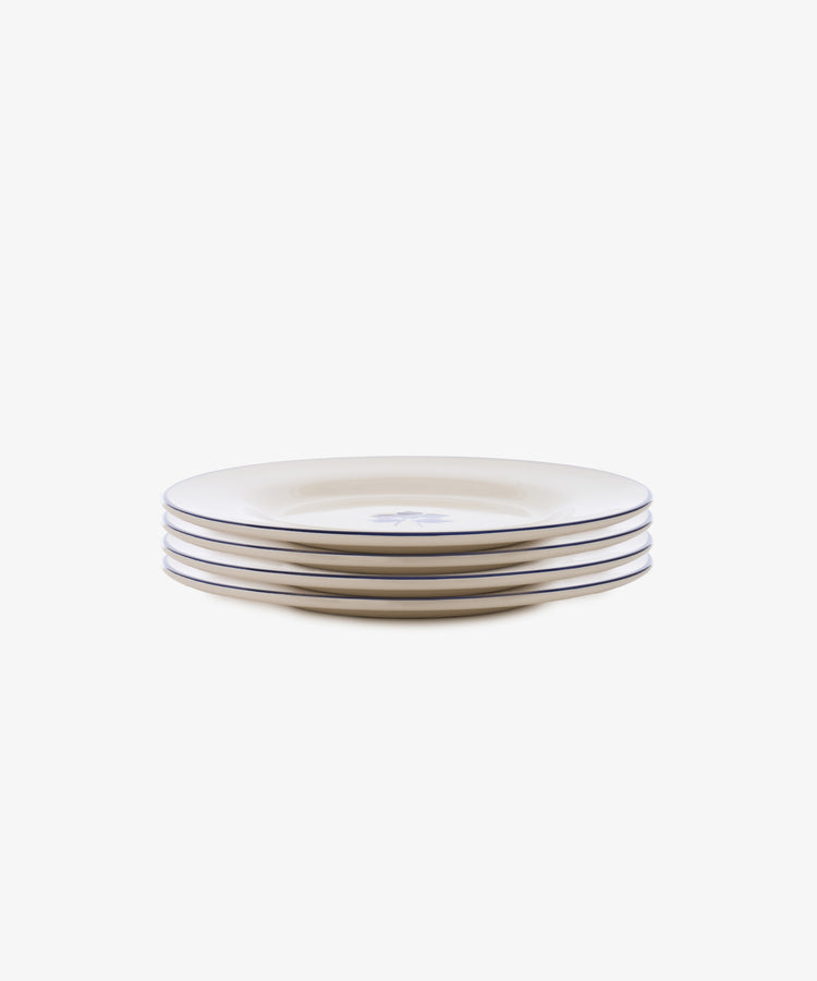 The Beatrix Salad Plate, Set of 4 features cream ceramic plates with a central botanical floral design, shown stacked side by side.