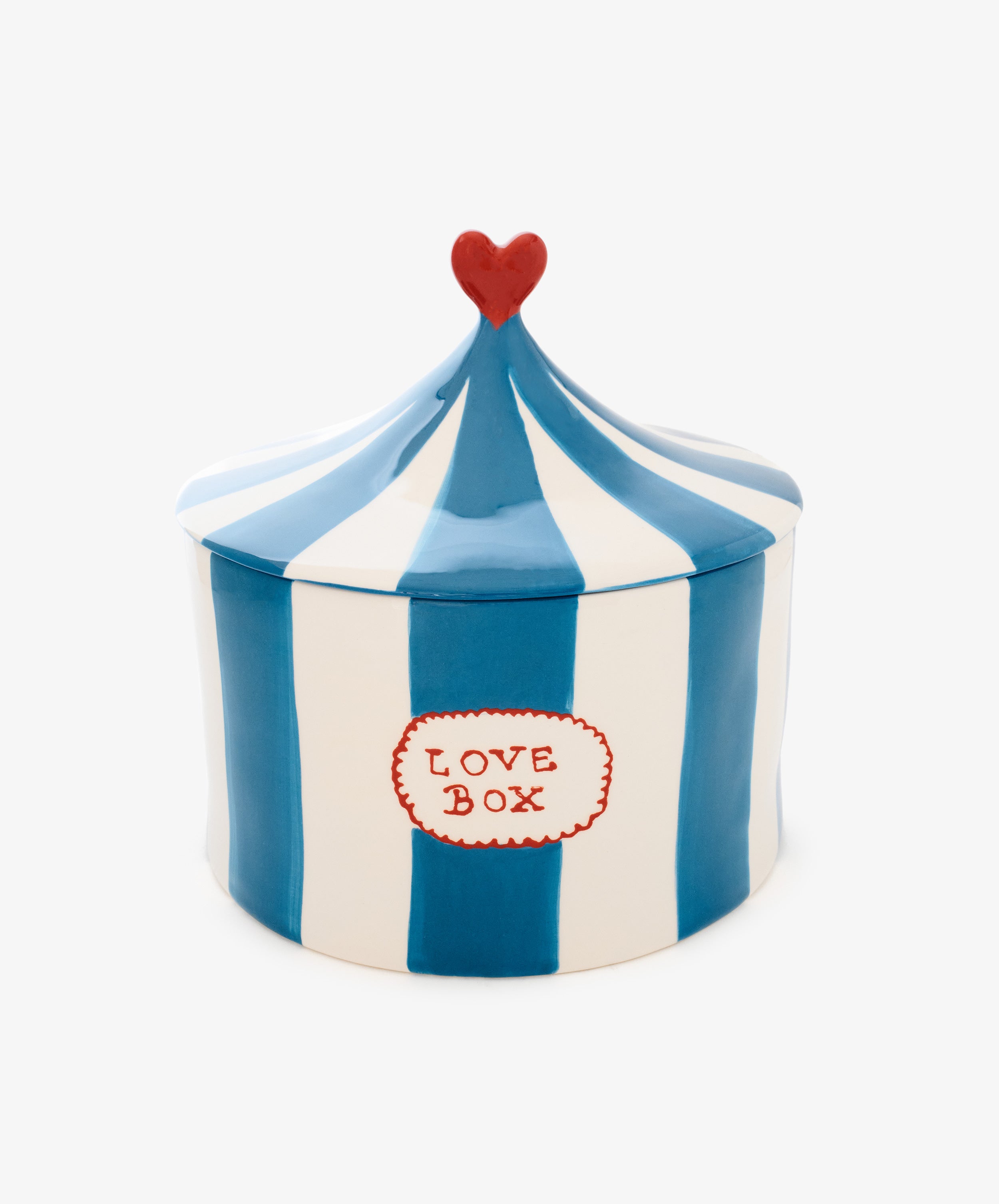 The Love Box is a hand-crafted blue and white striped ceramic storage box shaped like a circus tent, featuring a red heart on top and a label reading 