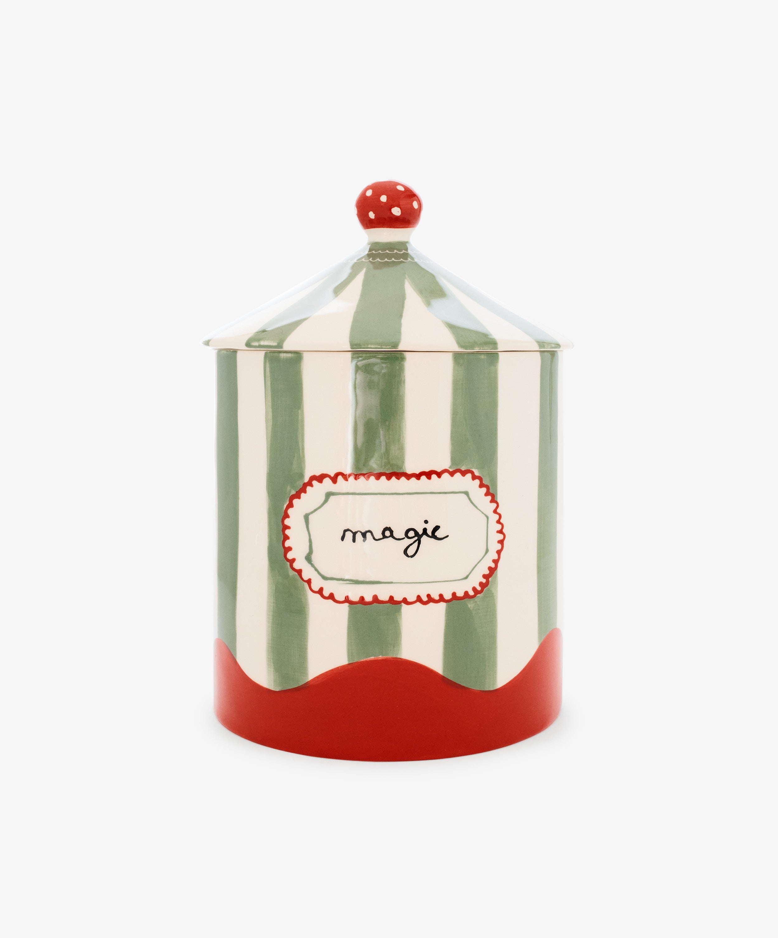 The Magic Box is a hand-crafted ceramic jar from Portugal, featuring vertical green and white stripes reminiscent of a circus tent, a red base, a red lid adorned with white dots, and a label reading 