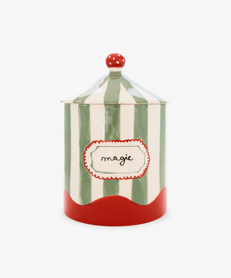 The Magic Box is a hand-crafted ceramic jar from Portugal, featuring vertical green and white stripes reminiscent of a circus tent, a red base, a red lid adorned with white dots, and a label reading 
