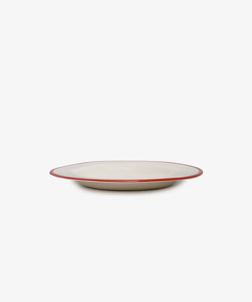 A handmade and unique beige ceramic plate called My main passion in life is bagel, featuring a thin red rim inspired by French artist Laetitia Rouget, displayed against a plain white background.