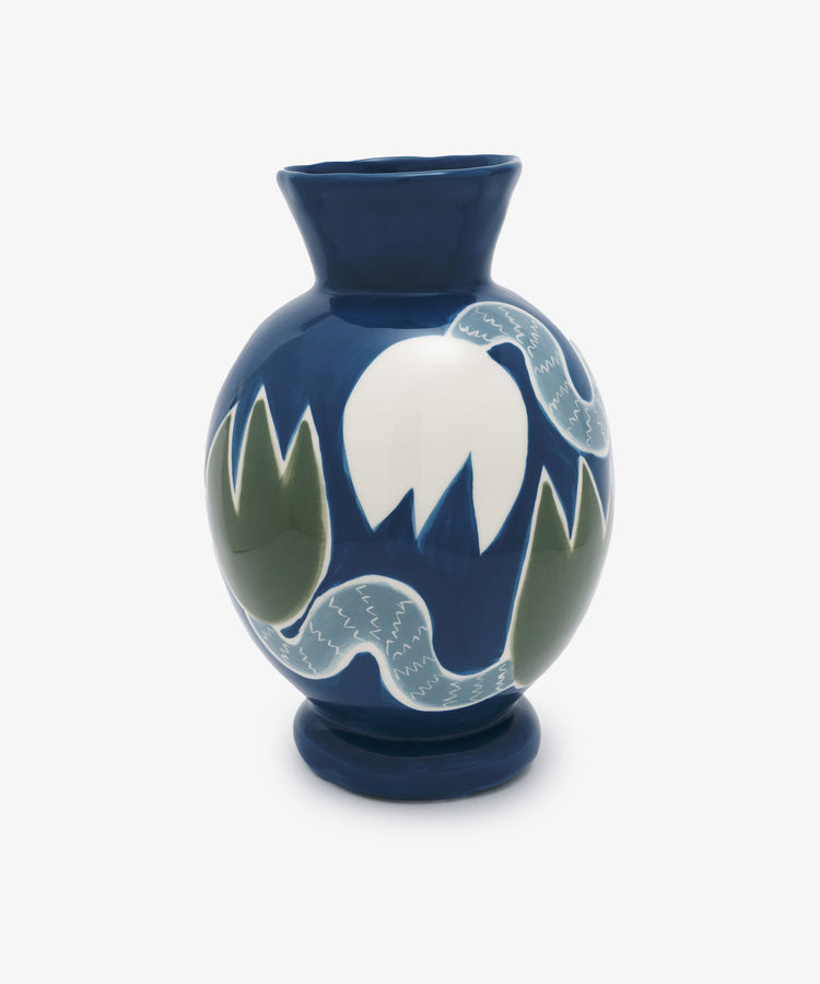 Tulip Flower Vase by Laetitia Rouget. Glazed ceramic vessel in indigo with white and green illustrated flowers.