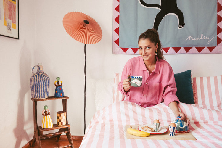 woman in bed eating breakfast