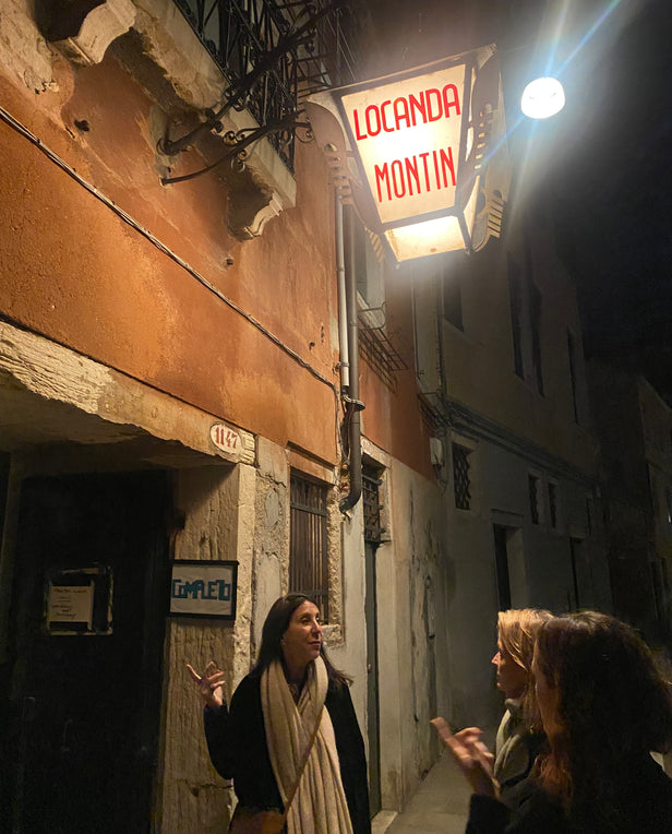 three woman walking into a restaurant at night