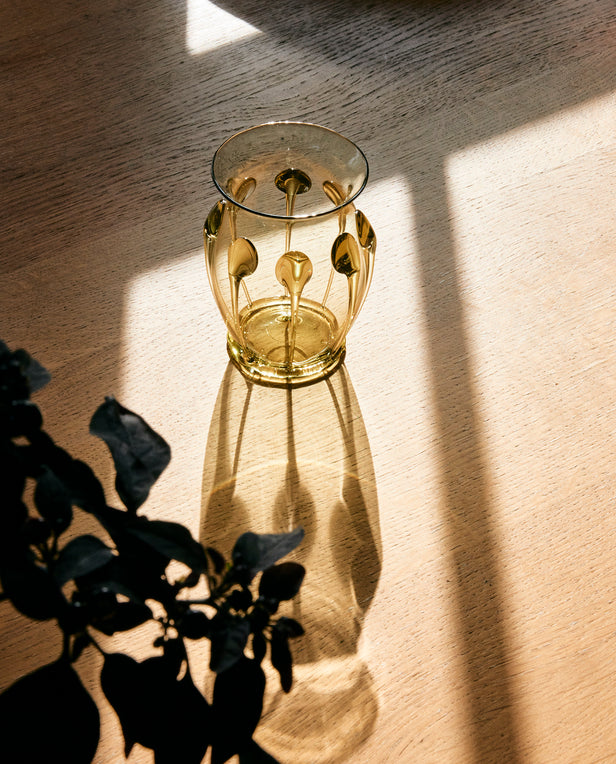 glass vase with dapper light on wood table