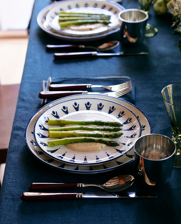 asparagus dish on plates on blue linen table