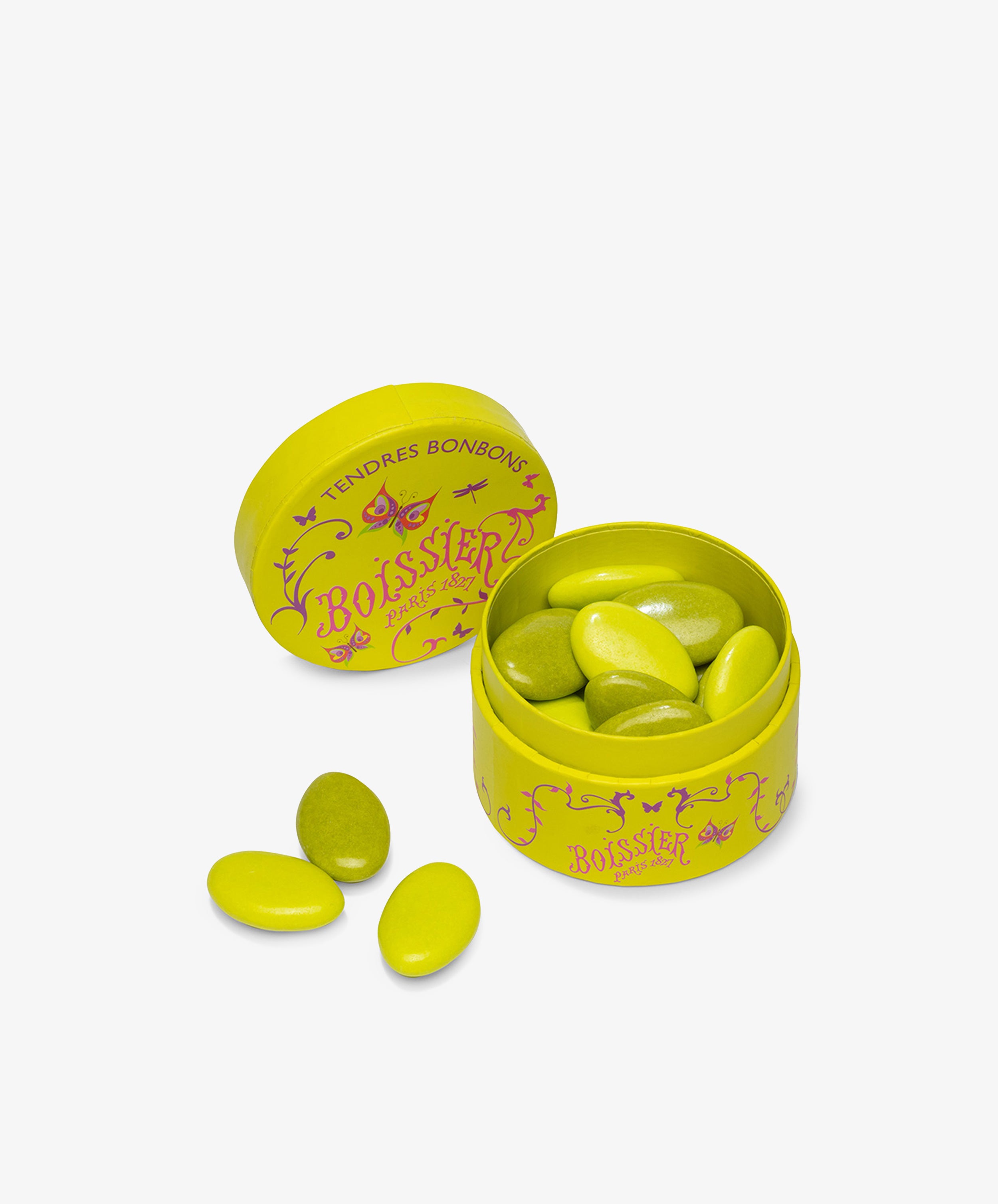 A round yellow tin labeled Boissier contains Multicolored Chocolate Gems in oval shapes of yellow and green, with the lid set beside the open container.