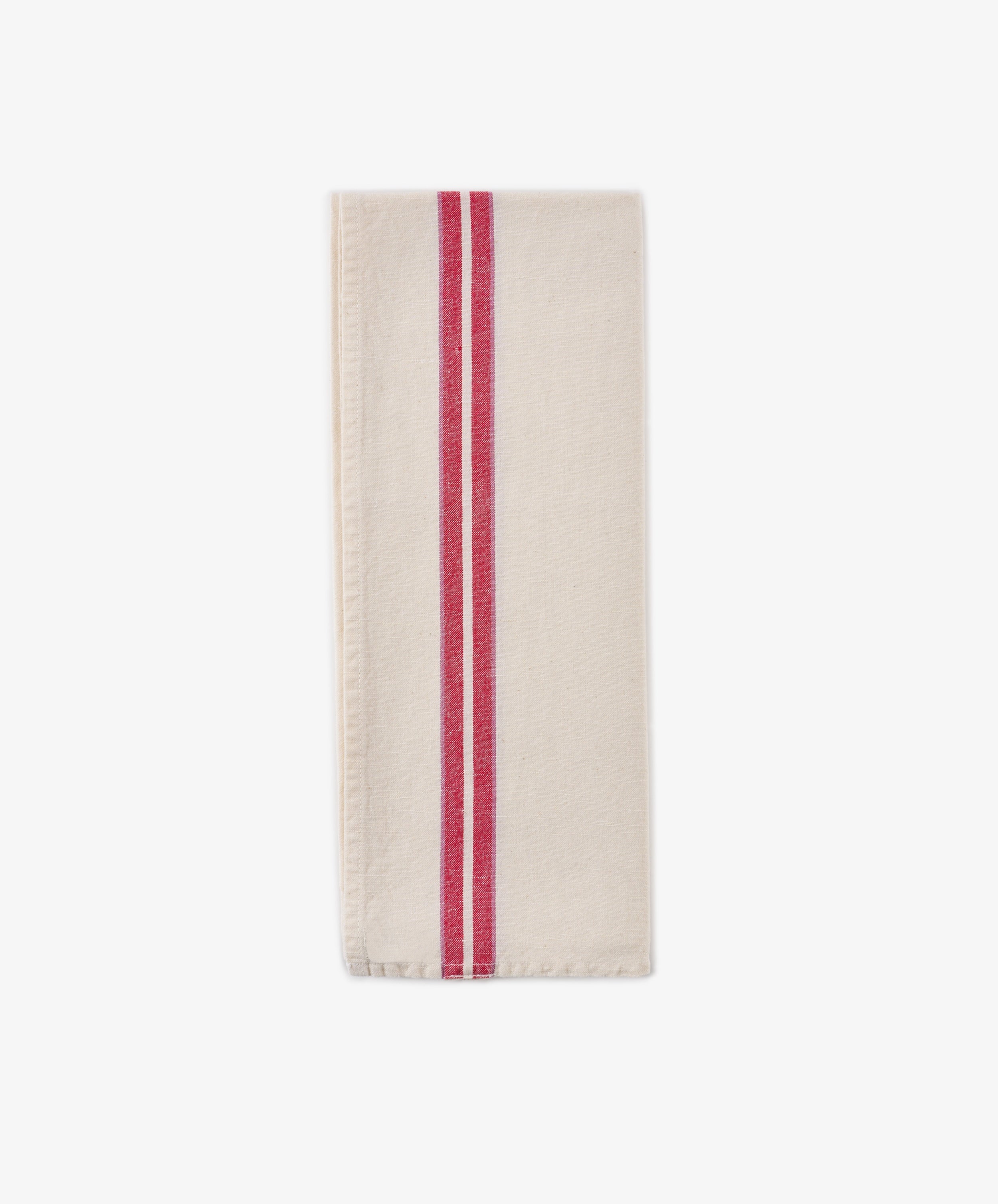 A folded Métis Tea Towel—cream-colored linen with two parallel red stripes running vertically near one edge, evocative of classic French kitchen linens—is displayed on a plain white background.