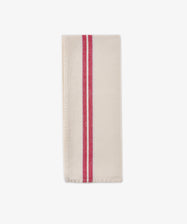 A folded Métis Tea Towel—cream-colored linen with two parallel red stripes running vertically near one edge, evocative of classic French kitchen linens—is displayed on a plain white background.