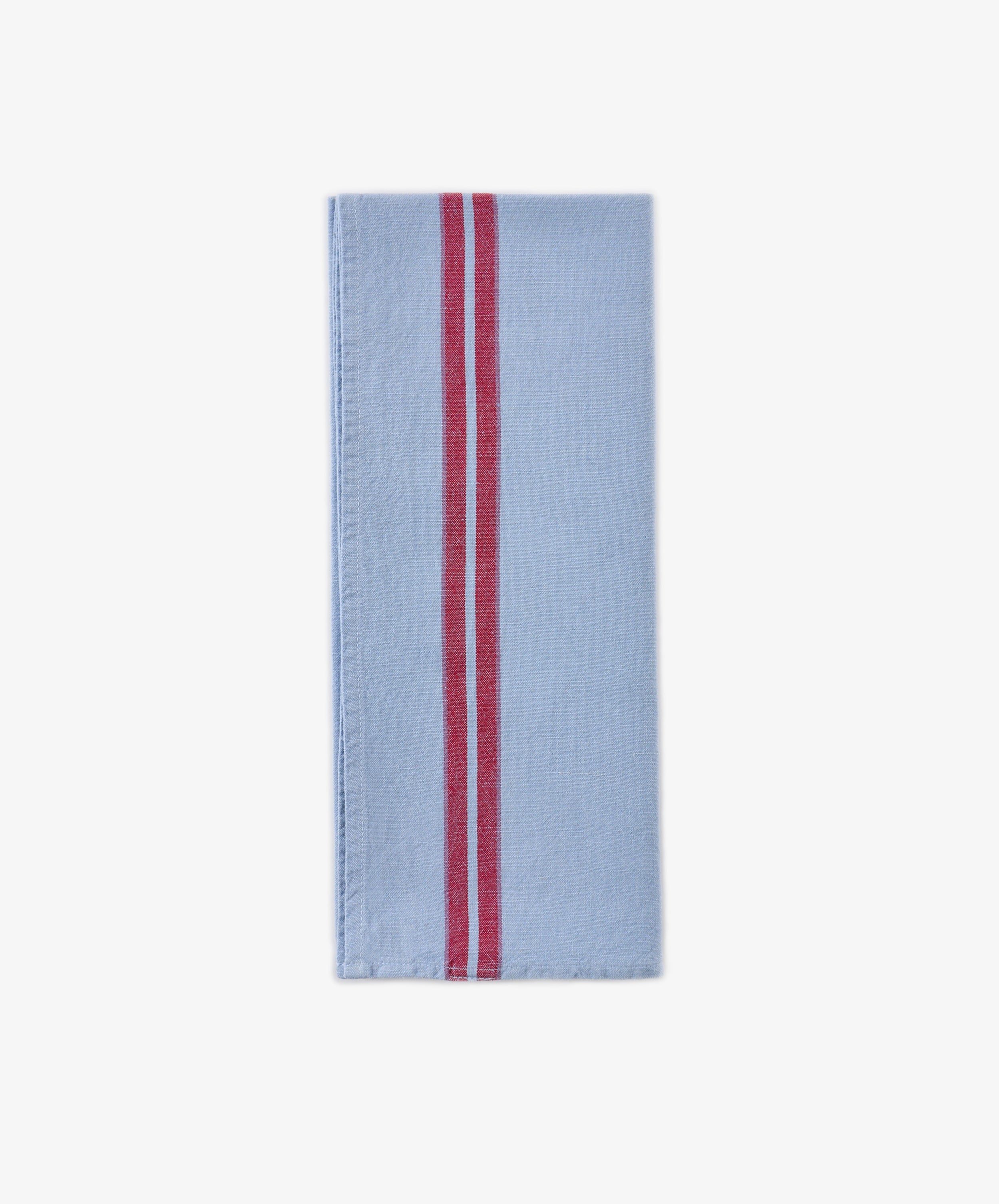 The Métis Tea Towel, crafted from light blue linen and featuring two parallel red stripes running vertically near the right edge, is displayed on a white background—a timeless piece inspired by classic French kitchen linens.
