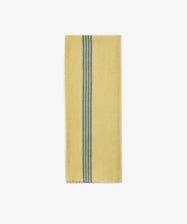A Métis Tea Towel, folded to showcase its yellow fabric accented by two parallel blue woven stripes running vertically near one edge—a design evocative of classic French kitchen linens—is displayed on a white background.