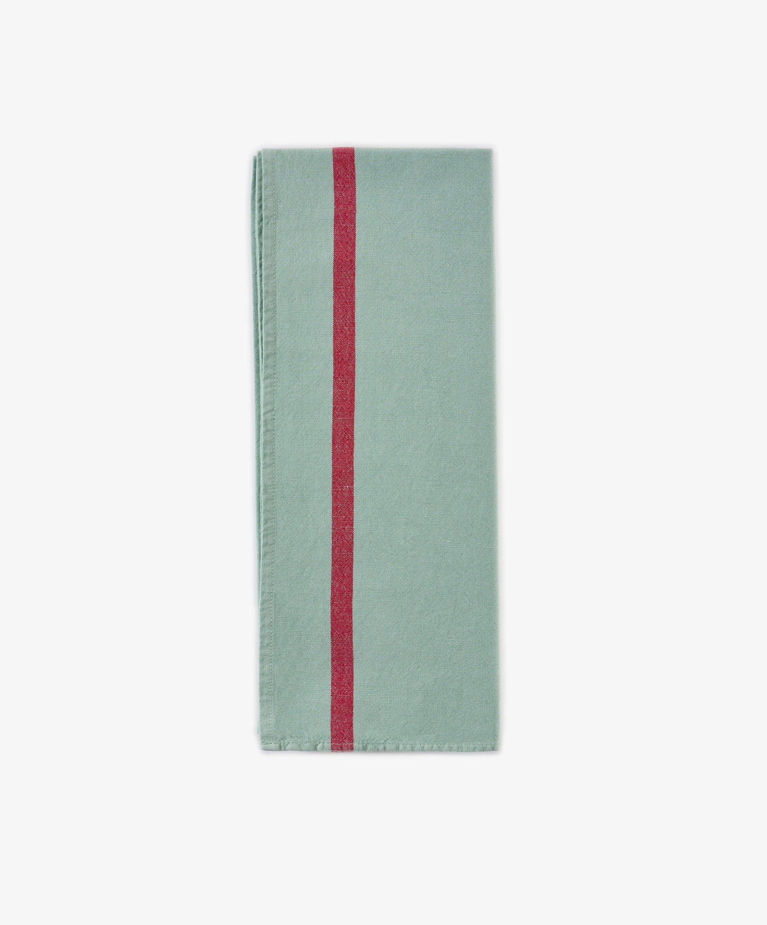 The Métis Tea Towel, in a folded light green hue and evoking vintage tea towel aesthetics, displays a single vertical red stripe near the left edge and is presented against a plain white background.
