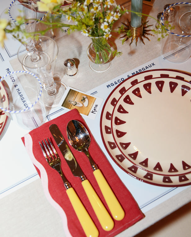 table with plate and cutlery on napkin