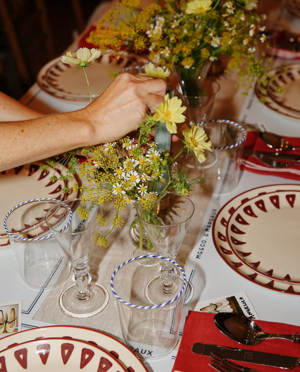 table with flower centerpieces and plates