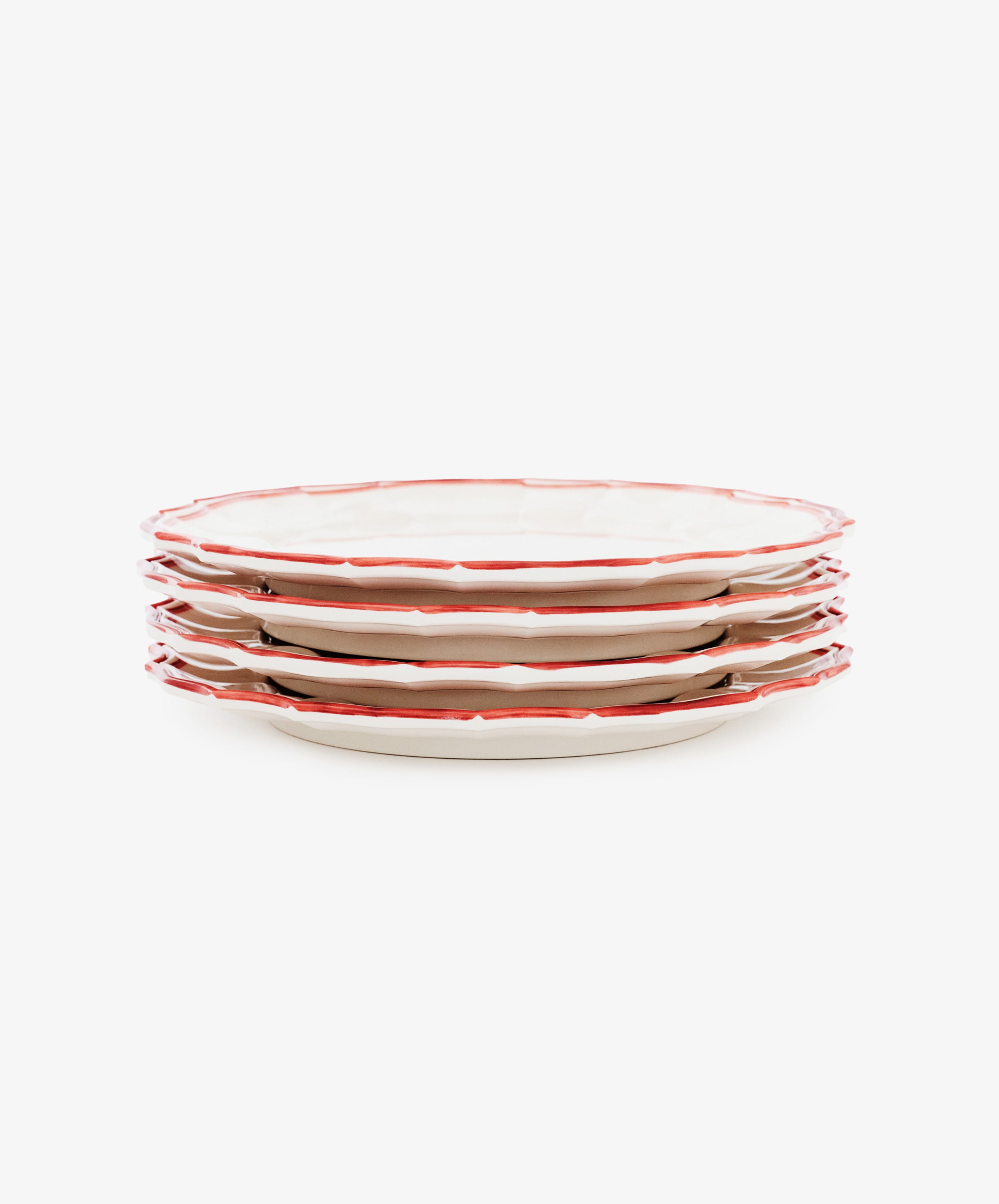 A set of four Eva Melamine Dinner Plates, featuring white surfaces with red, slightly scalloped edges, is arranged on a white background to highlight durable dinnerware that blends classic style with everyday practicality.
