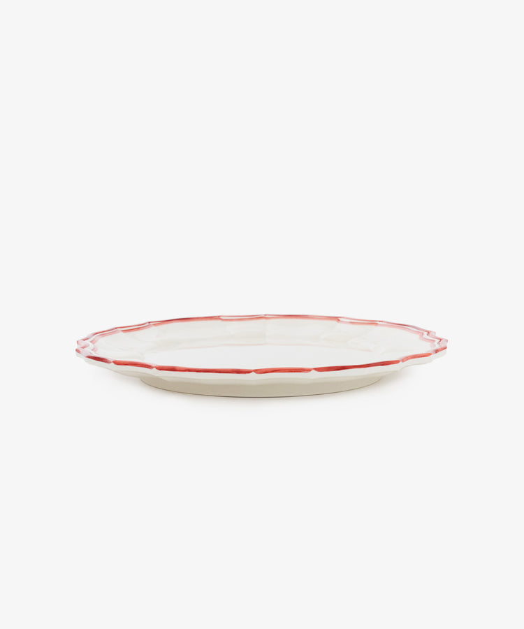 The Eva Melamine Dinner Plate, Set of 4, features a white plate with a scalloped edge and a red rim displayed on a white background, combining timeless elegance with durable dinnerware perfect for everyday use.