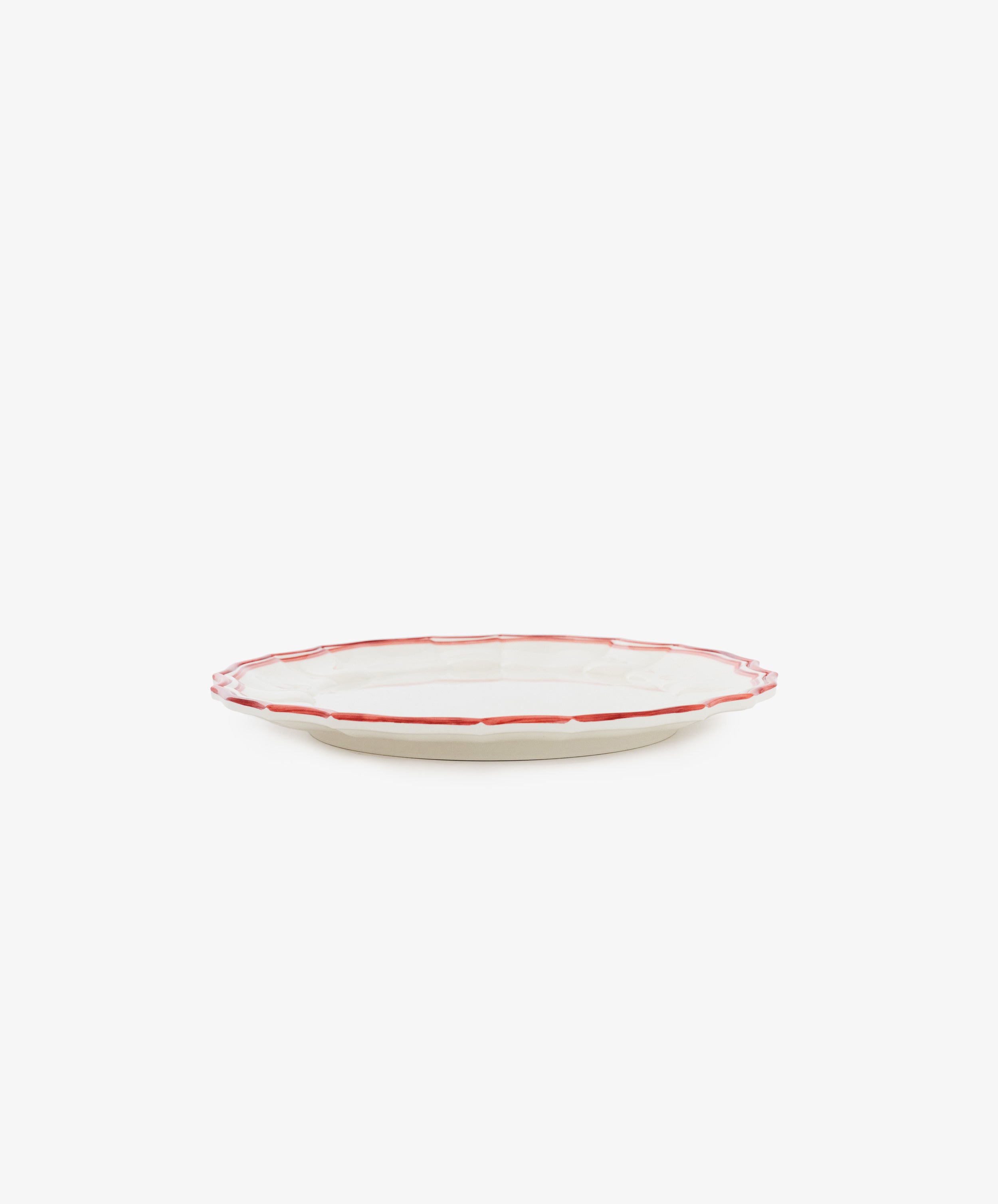 The Eva Melamine Small Plate, Set of 4, features round, beige plates with a slightly raised red-outlined rim—ideal for adding elegance and durability to your table setting.