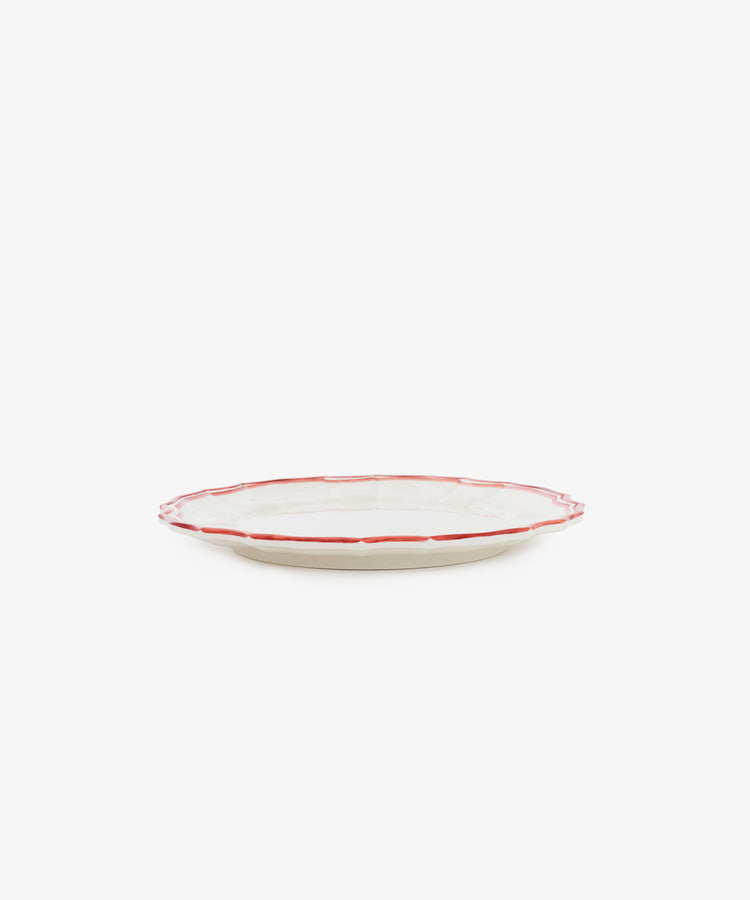 The Eva Melamine Small Plate, Set of 4, features round, beige plates with a slightly raised red-outlined rim—ideal for adding elegance and durability to your table setting.