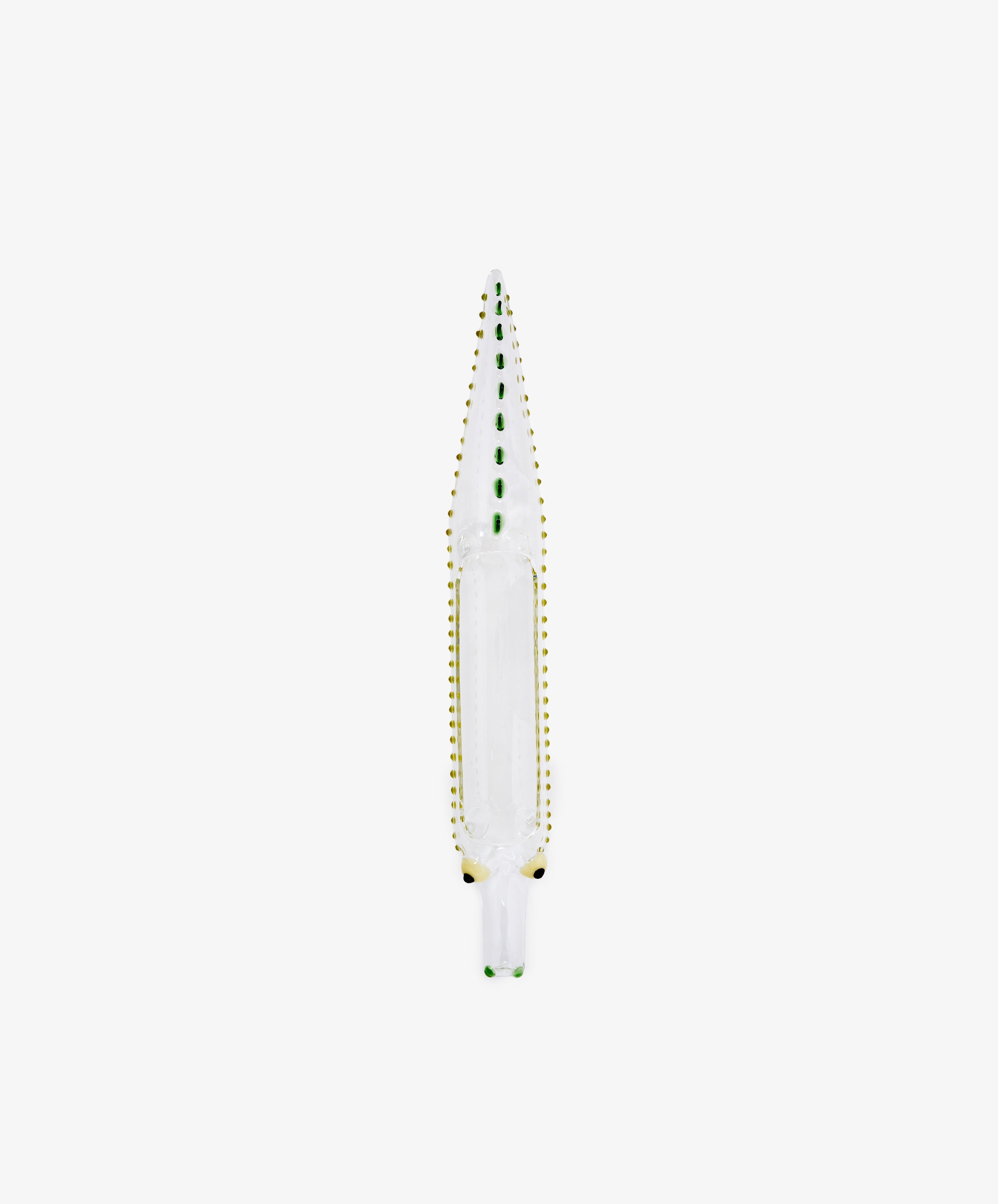 The Crokygris Centerpiece—a hand-blown borosilicate glass object shaped like a crocodile, adorned with green and yellow dotted accents—is showcased from above against a plain white background, exemplifying an exquisite glass crocodile centerpiece in the style of Massimo Lunardon.
