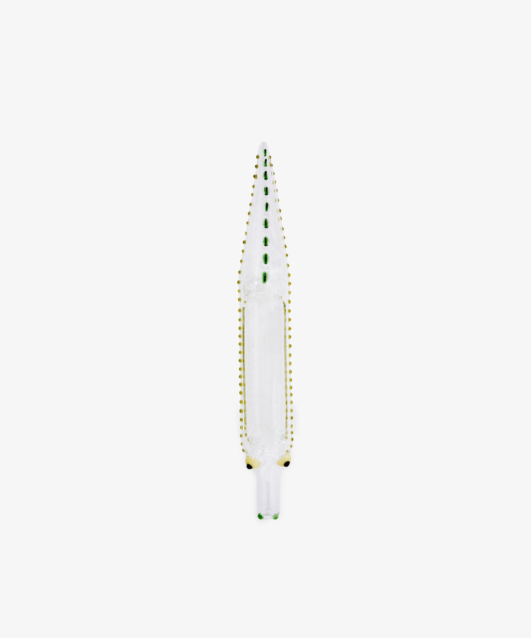 The Crokygris Centerpiece—a hand-blown borosilicate glass object shaped like a crocodile, adorned with green and yellow dotted accents—is showcased from above against a plain white background, exemplifying an exquisite glass crocodile centerpiece in the style of Massimo Lunardon.