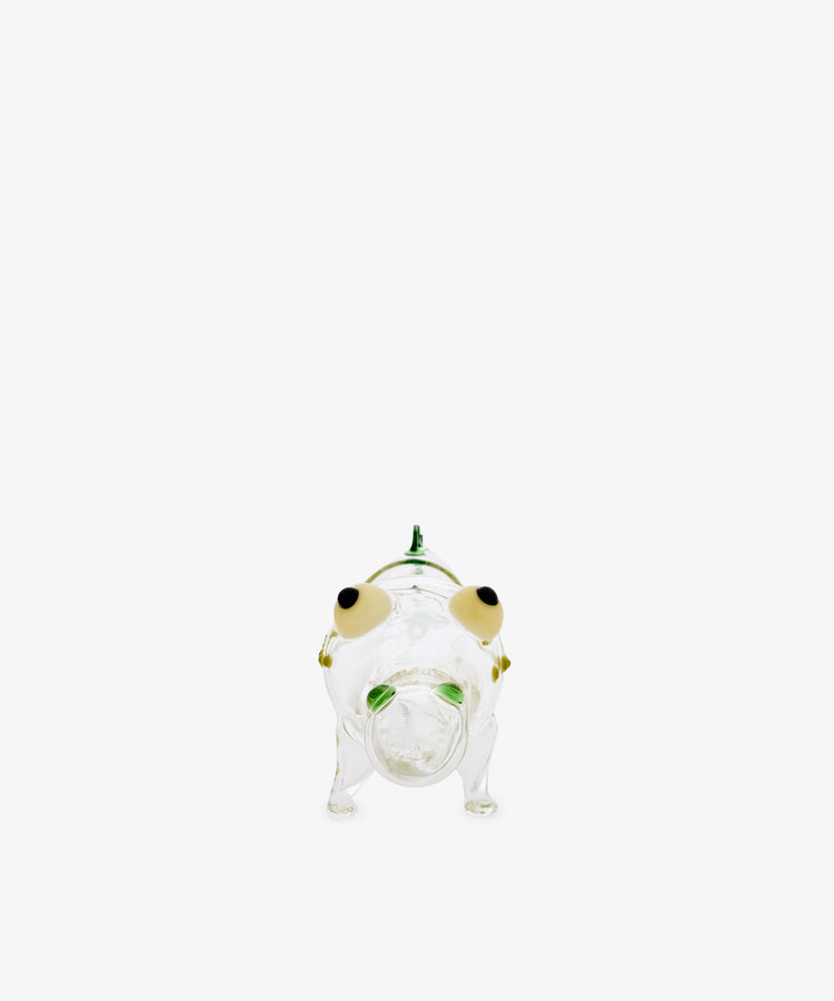The Crokygris Centerpiece is a clear glass animal figurine, possibly a frog, handcrafted in the style of Massimo Lunardon from hand-blown borosilicate glass. It features green and yellow accents and is photographed against a plain white background.