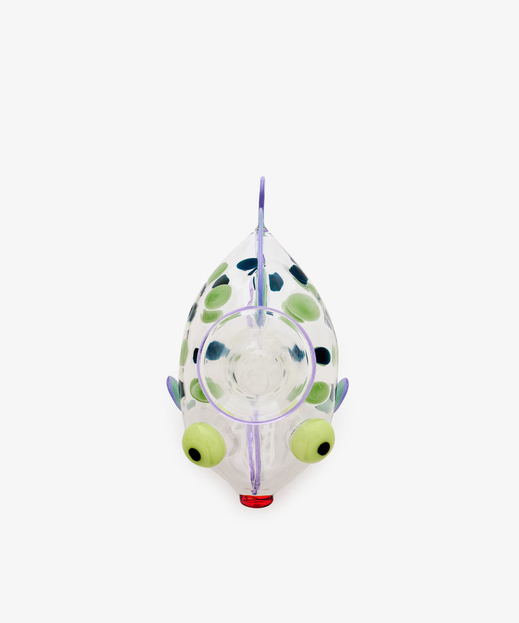 A Dotfish Decanter made from Murano glass, shaped like a fish and shown from above, features green eyes, blue spots, and a red mouth, displayed on a white background.