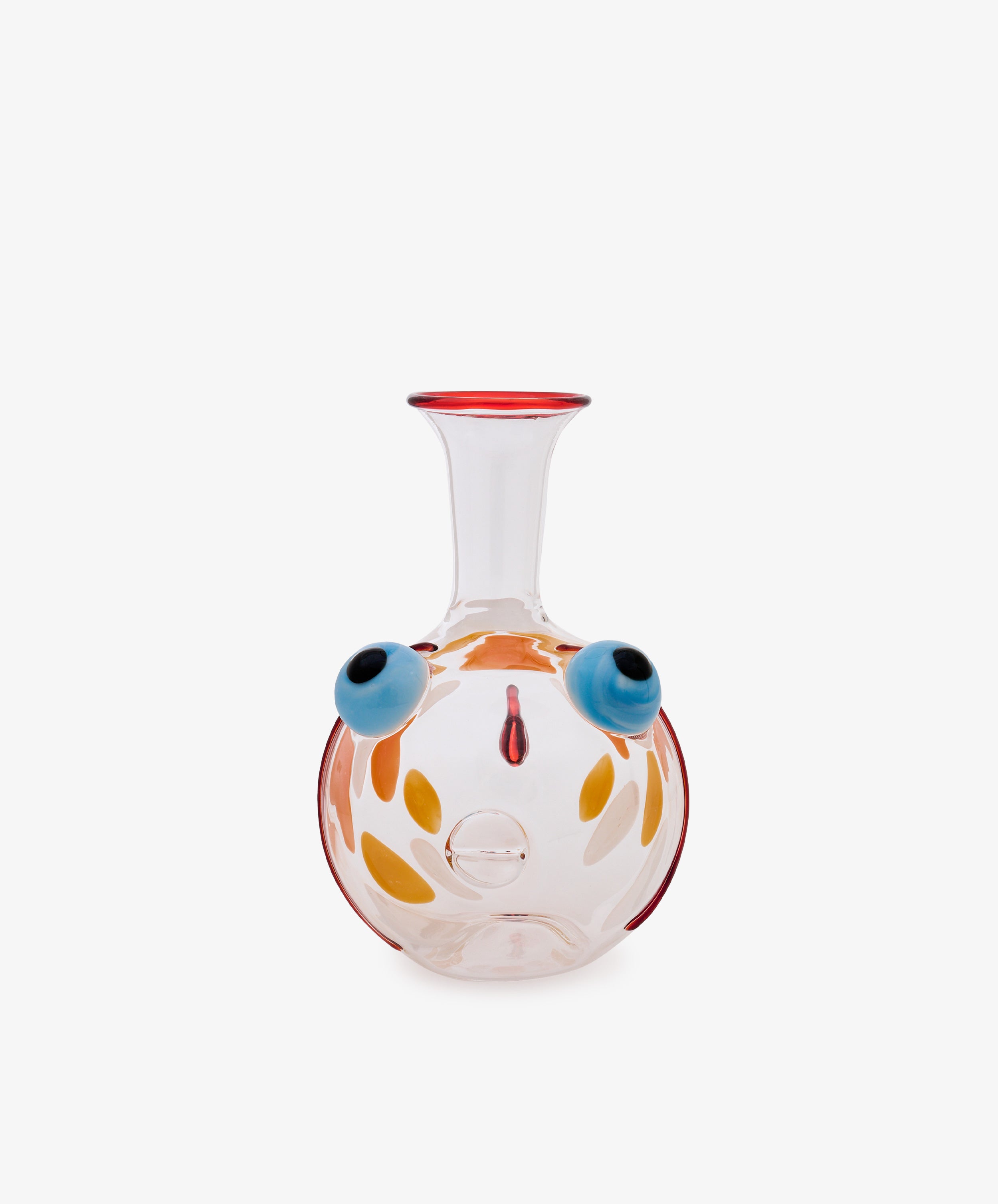 Fishpool Decanter crafted from clear Murano glass, featuring a wide round base and a narrow neck. The body is adorned with abstract, colorful designs reminiscent of facial features, including blue circular motifs and orange petal-like accents. Inspired by Massimo Lunardon’s whimsical artistry, this decanter channels the playful essence of his celebrated Fishpool collection.