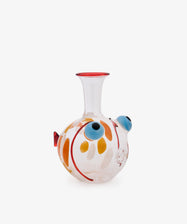 A hand-blown glass water pipe with a bulbous body decorated with orange, yellow, blue, and red patterns, featuring a narrow neck and a red rim, set against a plain white background.