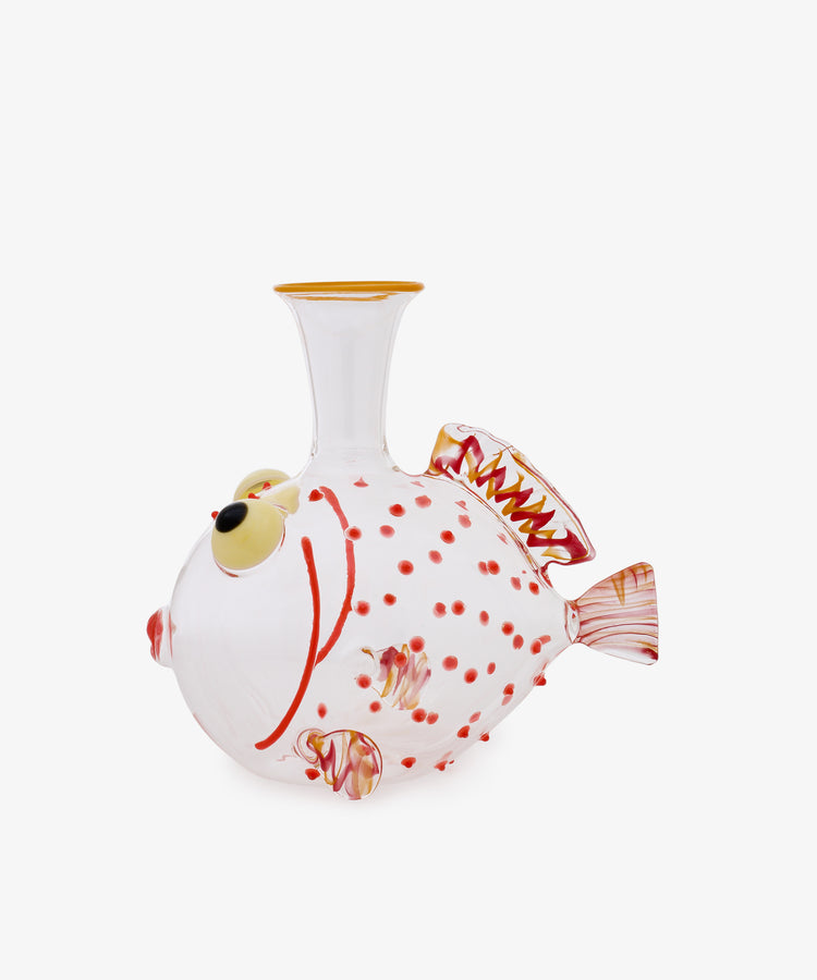 The Guppy Decanter, crafted from clear Murano glass in the shape of a fish, features red spots, yellow accents, and intricately detailed fins in Massimo Lunardon’s signature style, presented against a plain white background.