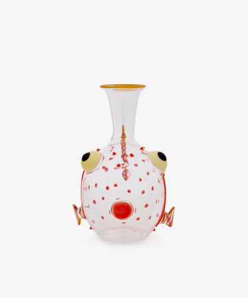 Guppy Decanter crafted from clear Murano glass features red spots, a yellow-rimmed mouth, protruding round eyes, and orange fin-like decorative elements along the sides. Set against a white background, this whimsical piece channels the playful style of Massimo Lunardon.