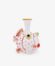 The Guppy Decanter, crafted from clear Murano glass in the whimsical shape of a fish and inspired by Massimo Lunardon’s playful style, features vibrant red spots, yellow-tinted fins, and large round eyes—creating a striking centerpiece when displayed against a white background.