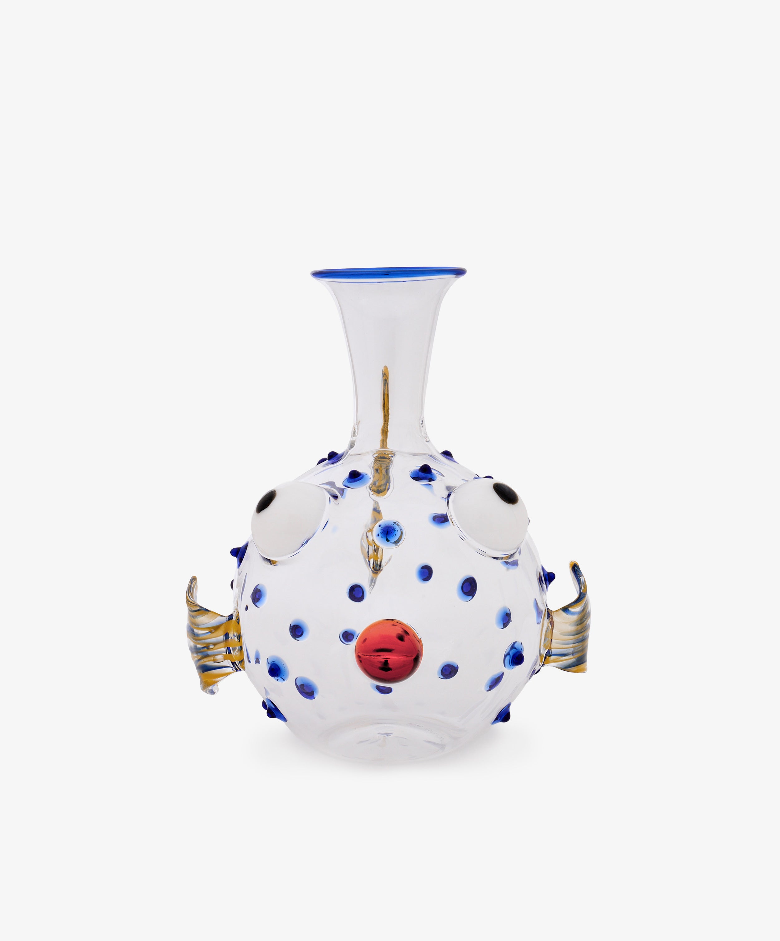 Pappagallo Decanter: Clear glass decanter shaped like a pufferfish, featuring cobalt blue spots, round eyes, gold fins, and a red mouth on a white background, reminiscent of Massimo Lunardon’s playful Murano glass designs.