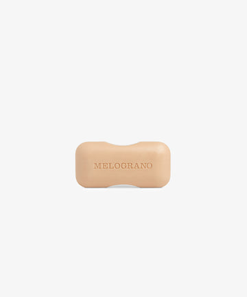 The Melograno Soap, a beige rectangular bar from Santa Maria Novella with rounded edges and embossed lettering, is displayed against a plain white background.