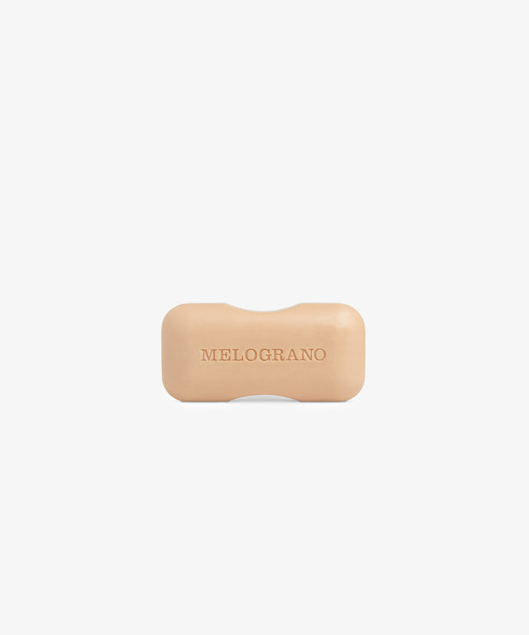 The Melograno Soap, a beige rectangular bar from Santa Maria Novella with rounded edges and embossed lettering, is displayed against a plain white background.