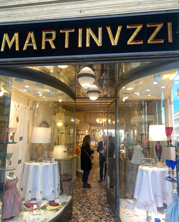 women inside a store talking to a man