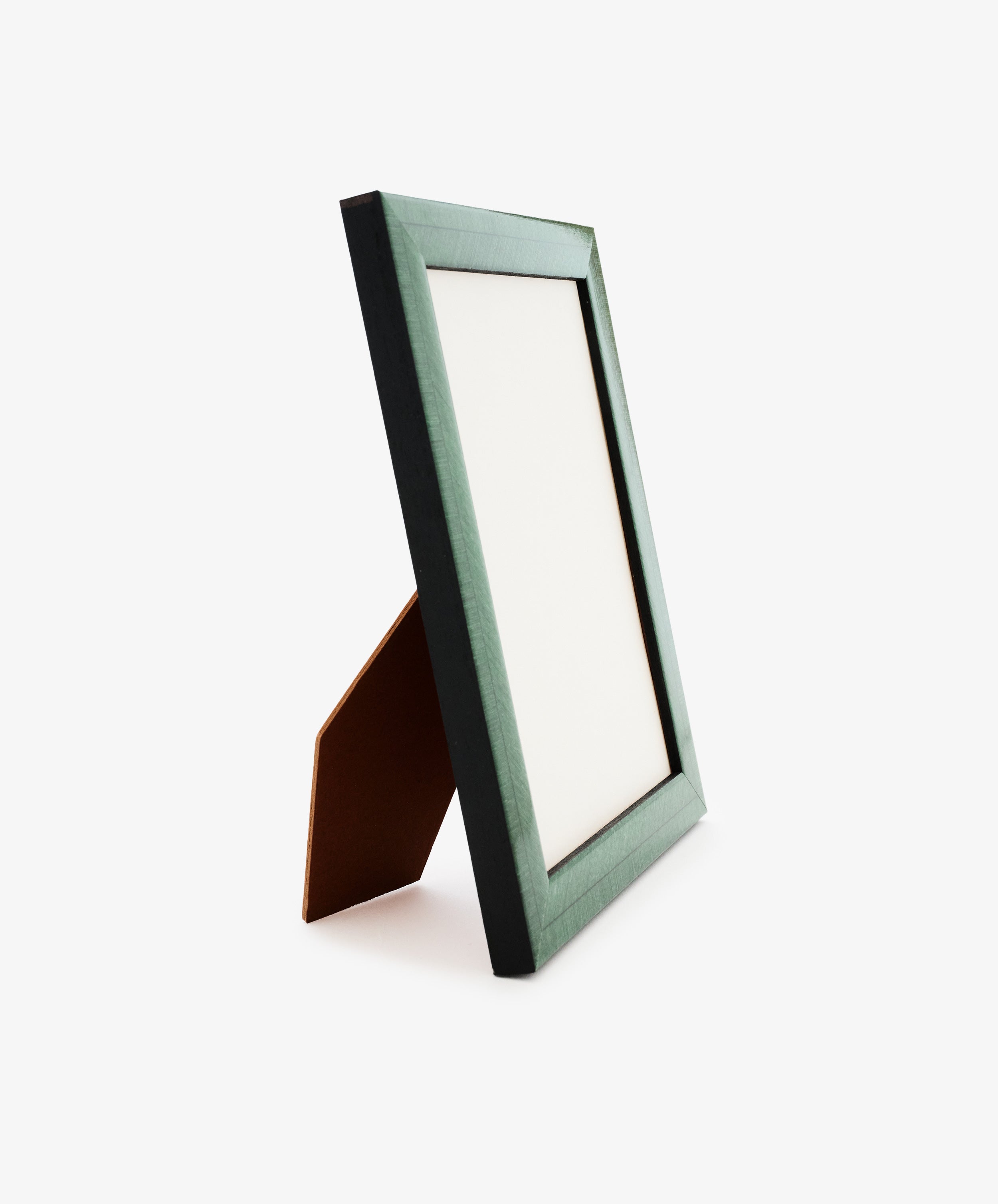 The Torino Frame, featuring a green border and a wood construction with precision craftsmanship, stands upright on a brown support against a white background.