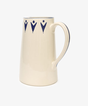 The Vito Jug is a cream-colored ceramic jug with a large handle, decorated with blue geometric shapes near the rim—a stylish and unique gift for any occasion.