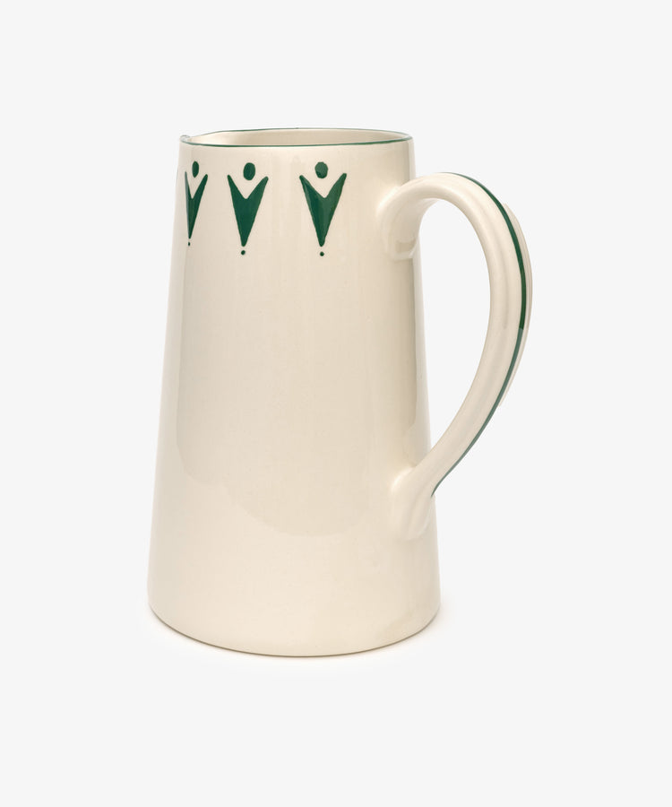 The Vito Jug is a cream ceramic piece with a curved handle and green geometric accents by the rim—handmade to add charm to any unique glassware collection.