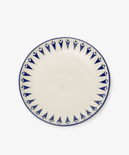 The Vito Serving Platter is a round ceramic piece with a cream center and blue geometric rim, showcasing understated handmade style.