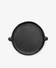 The Chamba Plate is a round, flat black clay plate with two small side handles, shown on a plain white background.