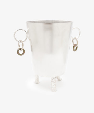 The Inge Ice Bucket displays fine Italian craftsmanship with textured silver metal, tripod legs, two large ring handles, and smaller circular ornaments, all set against a plain white background.